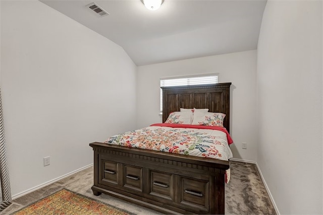 bedroom with visible vents, baseboards, vaulted ceiling, and carpet