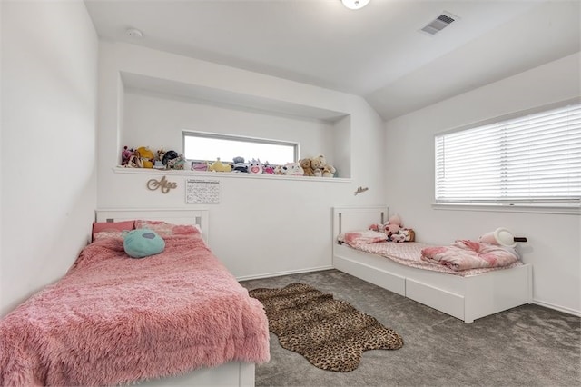 bedroom with carpet, vaulted ceiling, multiple windows, and visible vents
