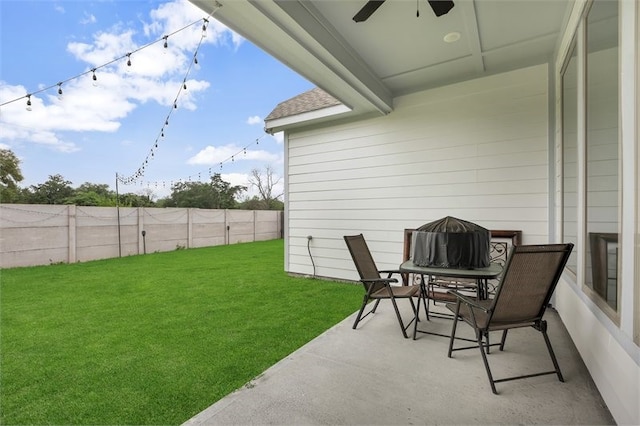 view of yard with a fenced backyard and ceiling fan