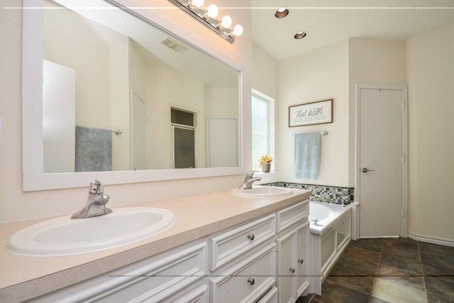 full bath with a garden tub, a shower stall, double vanity, stone finish flooring, and recessed lighting