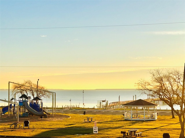 view of property's community featuring a gazebo, playground community, and a water view