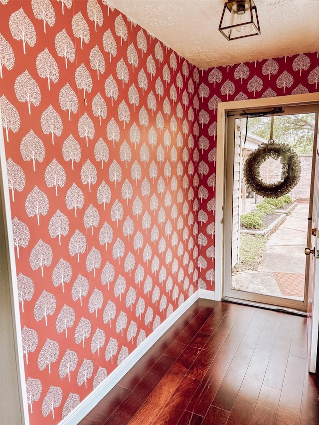 16111 Queensdale Dr, Houston, TX 77082 - interior space featuring dark wood-style flooring, wallpapered walls, and baseboards