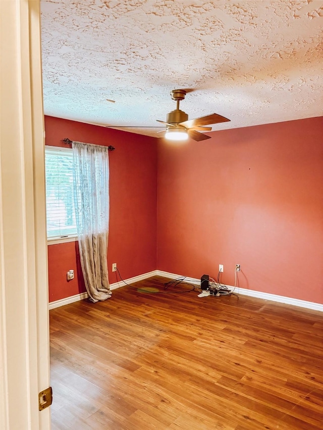 16111 Queensdale Dr, Houston, TX 77082 - empty room with a textured ceiling, ceiling fan, baseboards, and light wood finished floors