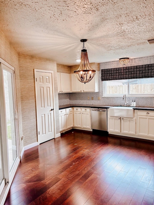 16111 Queensdale Dr, Houston, TX 77082 - kitchen with stainless steel dishwasher, dark countertops, plenty of natural light, and a sink