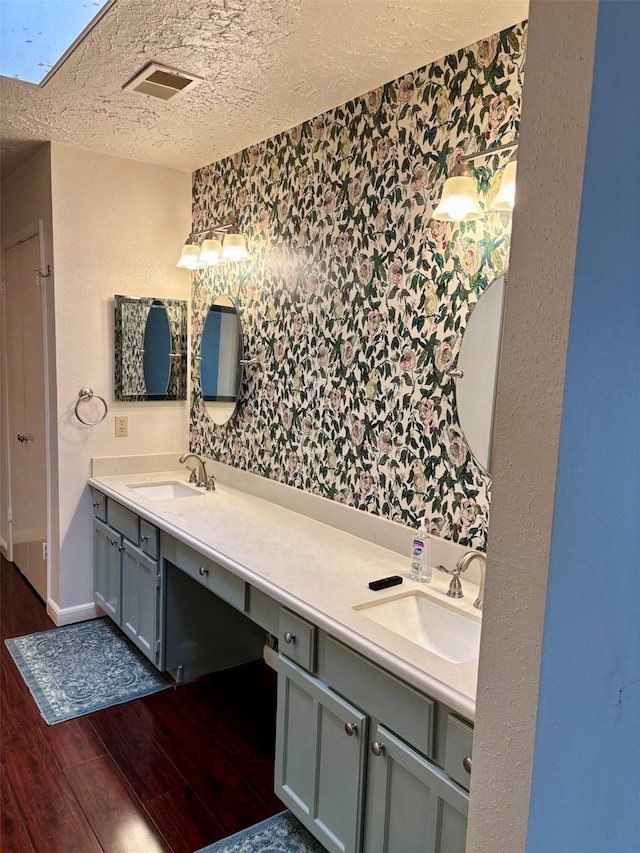 16111 Queensdale Dr, Houston, TX 77082 - full bathroom with visible vents, a sink, a textured ceiling, and wood finished floors
