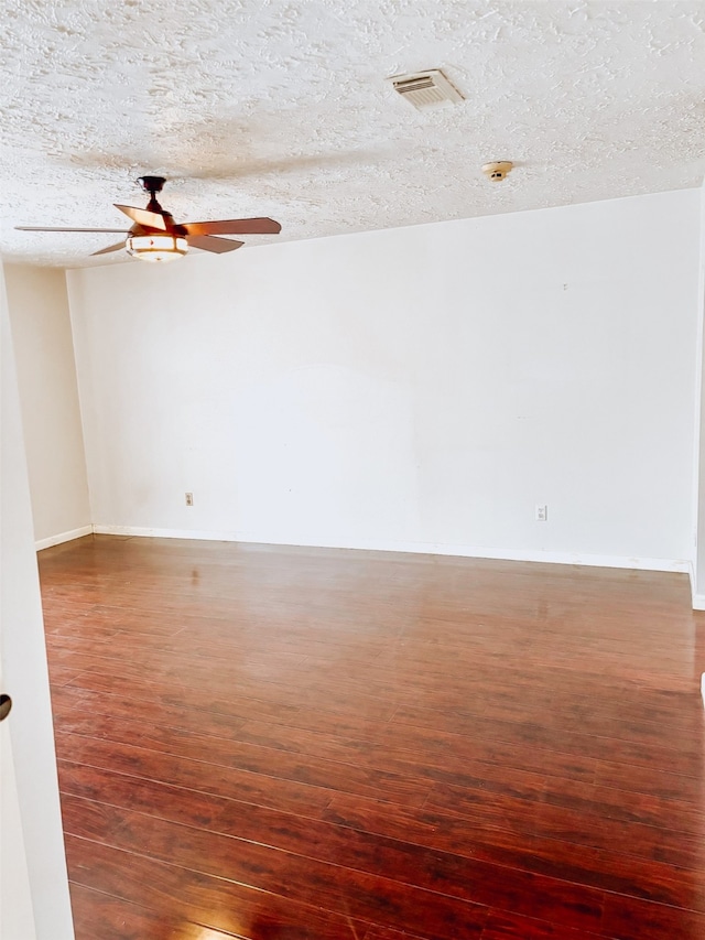 16111 Queensdale Dr, Houston, TX 77082 - unfurnished room with a ceiling fan, a textured ceiling, visible vents, wood finished floors, and baseboards