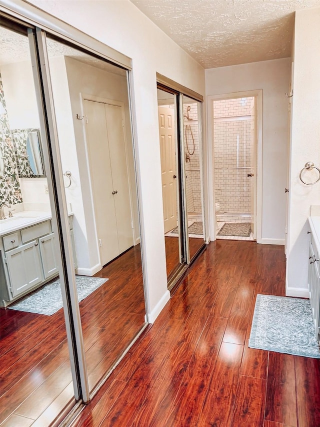 16111 Queensdale Dr, Houston, TX 77082 - interior space featuring baseboards, a textured ceiling, and wood finished floors