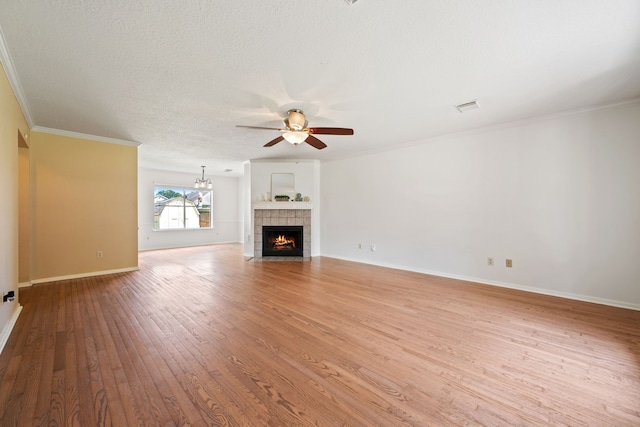 4309 Kingfish Dr, Seabrook, TX 77586 - unfurnished living room with a ceiling fan, wood finished floors, ornamental molding, a tiled fireplace, and baseboards