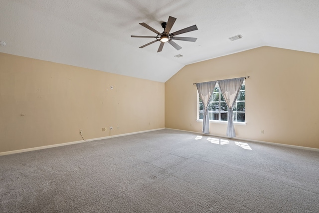 unfurnished room featuring visible vents, ceiling fan, carpet, and lofted ceiling