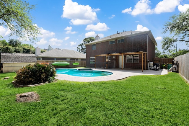 view of pool with a patio area, a fenced in pool, a yard, a fenced backyard, and a storage shed