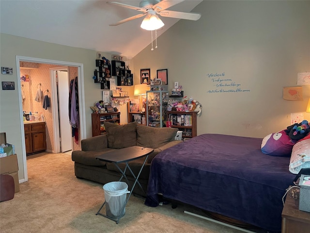 carpeted bedroom featuring connected bathroom, ceiling fan, and vaulted ceiling