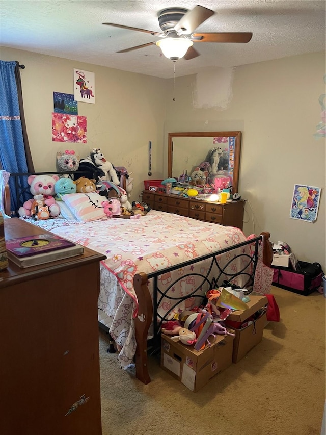 bedroom featuring carpet floors, a ceiling fan, and a textured ceiling