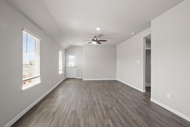 unfurnished living room with baseboards, a ceiling fan, and dark wood-style floors