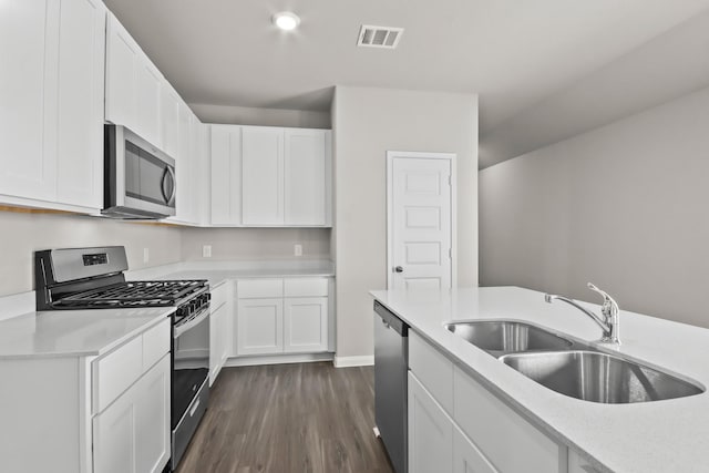 kitchen with light countertops, visible vents, stainless steel appliances, and a sink