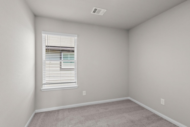 carpeted empty room with baseboards and visible vents