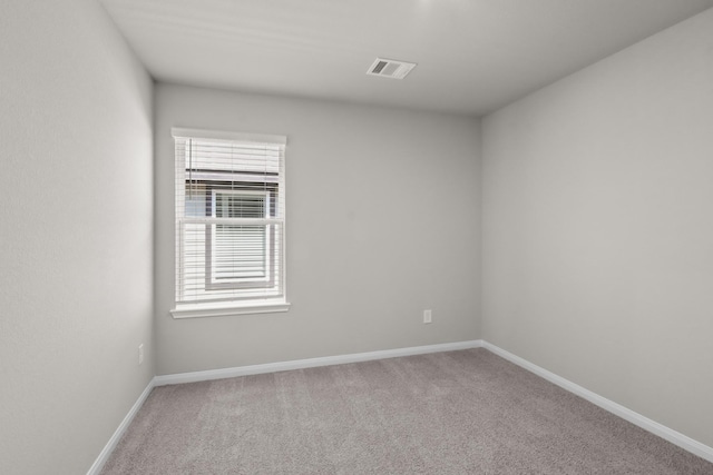 carpeted empty room with baseboards, visible vents, and a healthy amount of sunlight