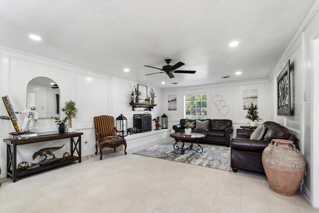9203 Mauna Loa Ln, Houston, TX 77040 - living room with arched walkways, a decorative wall, a fireplace with raised hearth, and a ceiling fan