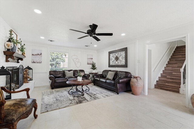 9203 Mauna Loa Ln, Houston, TX 77040 - living room with a decorative wall, a ceiling fan, a fireplace, crown molding, and stairs