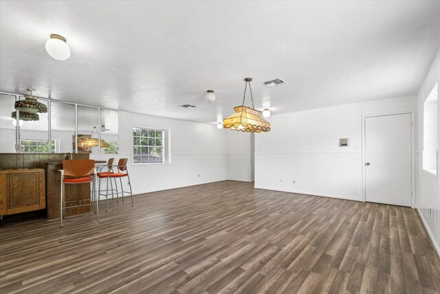 9203 Mauna Loa Ln, Houston, TX 77040 - unfurnished living room featuring dark wood-style flooring and visible vents