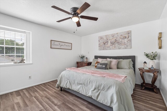 9203 Mauna Loa Ln, Houston, TX 77040 - bedroom featuring wood finished floors, baseboards, and a ceiling fan