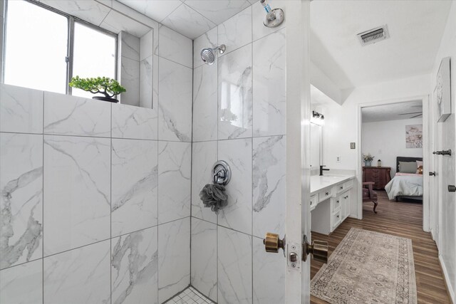 9203 Mauna Loa Ln, Houston, TX 77040 - full bathroom featuring vanity, ensuite bathroom, a marble finish shower, visible vents, and wood finished floors