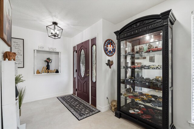 9203 Mauna Loa Ln, Houston, TX 77040 - entrance foyer with baseboards and a notable chandelier