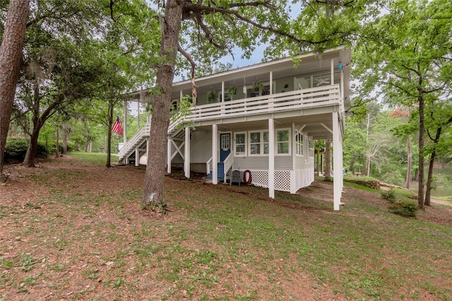 101 Tony Ln, Huntsville, TX 77320 - back of house featuring a carport and stairway