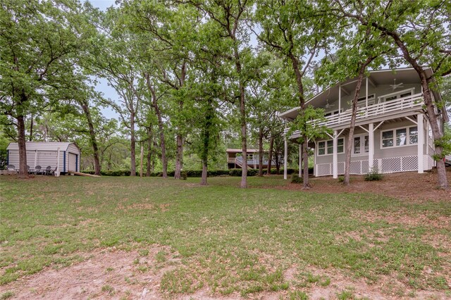 101 Tony Ln, Huntsville, TX 77320 - view of yard featuring an outbuilding, ceiling fan, and a balcony