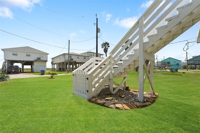 1014 Blue Water Hwy, Surfside Beach, TX 77541 - view of yard featuring a garage, driveway, and stairs