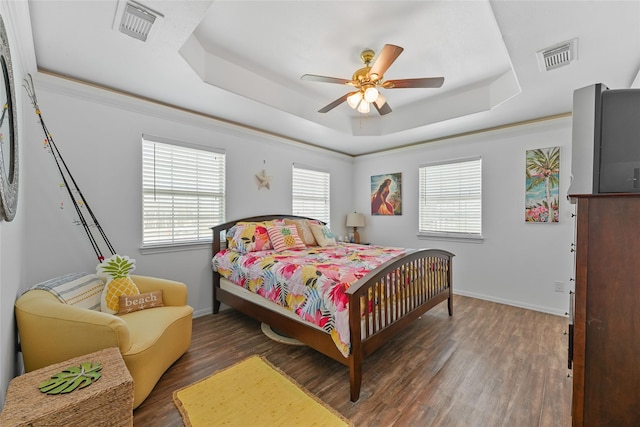 1014 Blue Water Hwy, Surfside Beach, TX 77541 - bedroom with a tray ceiling, wood finished floors, and visible vents