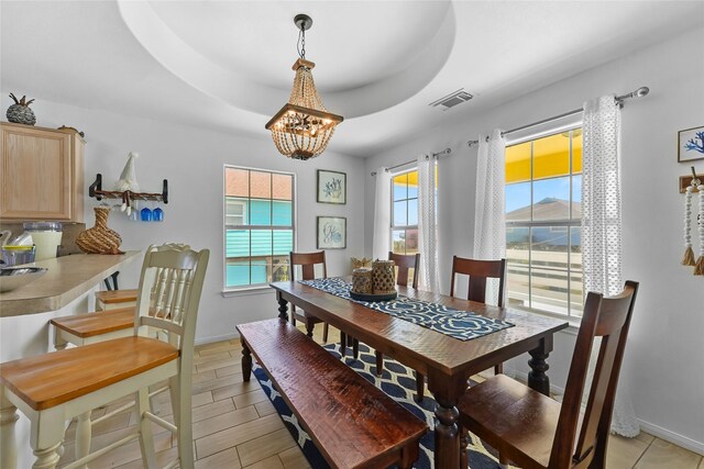 1014 Blue Water Hwy, Surfside Beach, TX 77541 - dining room featuring visible vents, baseboards, a raised ceiling, and an inviting chandelier
