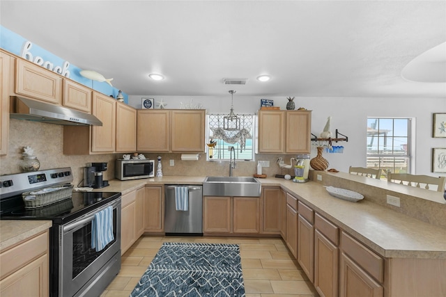 1014 Blue Water Hwy, Surfside Beach, TX 77541 - kitchen featuring a sink, appliances with stainless steel finishes, light brown cabinets, and under cabinet range hood