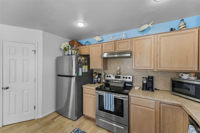 1014 Blue Water Hwy, Surfside Beach, TX 77541 - kitchen with tasteful backsplash, light brown cabinets, light countertops, under cabinet range hood, and stainless steel appliances