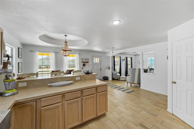 1014 Blue Water Hwy, Surfside Beach, TX 77541 - kitchen featuring pendant lighting, a peninsula, light countertops, open floor plan, and light wood finished floors