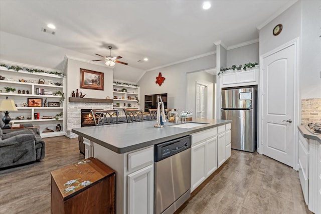 137 Gray Vervain Ct, Montgomery, TX 77316 - kitchen featuring open floor plan, a kitchen island with sink, ceiling fan, appliances with stainless steel finishes, and visible vents