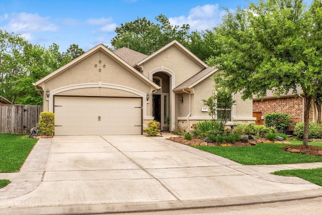 137 Gray Vervain Ct, Montgomery, TX 77316 - view of front facade featuring stucco siding, an attached garage, driveway, and fence