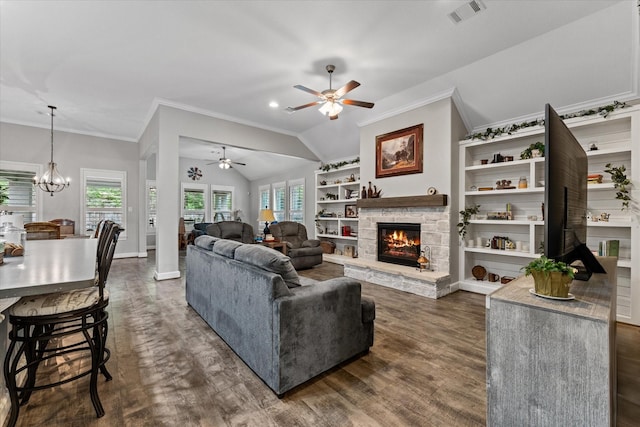 137 Gray Vervain Ct, Montgomery, TX 77316 - living area with crown molding, ceiling fan with notable chandelier, a fireplace, dark wood-type flooring, and visible vents