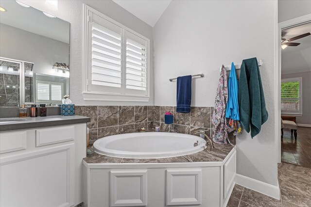 137 Gray Vervain Ct, Montgomery, TX 77316 - full bathroom with a bath, vanity, ceiling fan, baseboards, and lofted ceiling