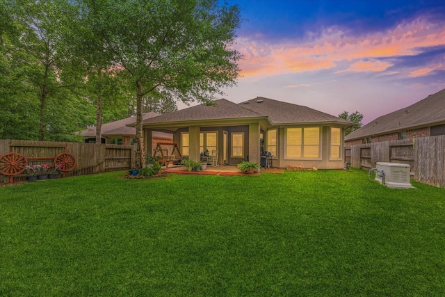 137 Gray Vervain Ct, Montgomery, TX 77316 - back of house with a fenced backyard, a patio, and a lawn