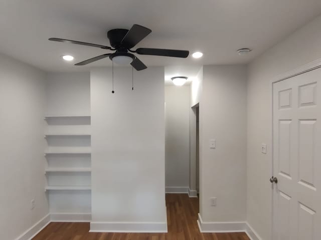 interior space with baseboards, a ceiling fan, wood finished floors, and recessed lighting