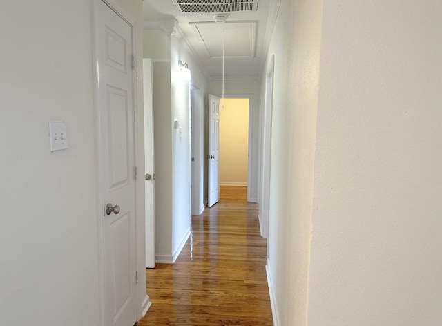 11026 Catamore St, Houston, TX 77076 - hallway featuring attic access, wood finished floors, ornamental molding, and baseboards