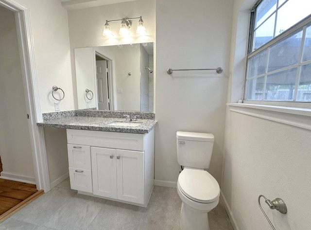 11026 Catamore St, Houston, TX 77076 - bathroom featuring vanity, toilet, tile patterned floors, and baseboards