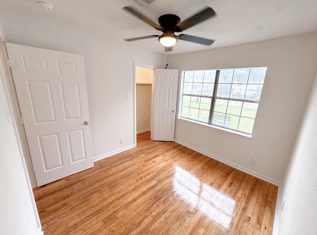 11026 Catamore St, Houston, TX 77076 - unfurnished bedroom with baseboards, light wood finished floors, a spacious closet, ceiling fan, and a closet