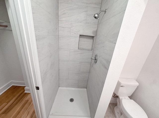 11026 Catamore St, Houston, TX 77076 - full bath featuring a shower stall, toilet, and wood finished floors