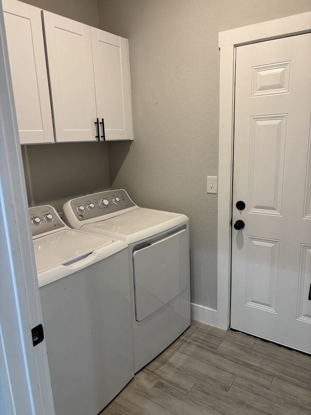 15888 Chestnut Dr, Montgomery, TX 77356 - laundry area with washer and dryer, wood finish floors, baseboards, and cabinet space