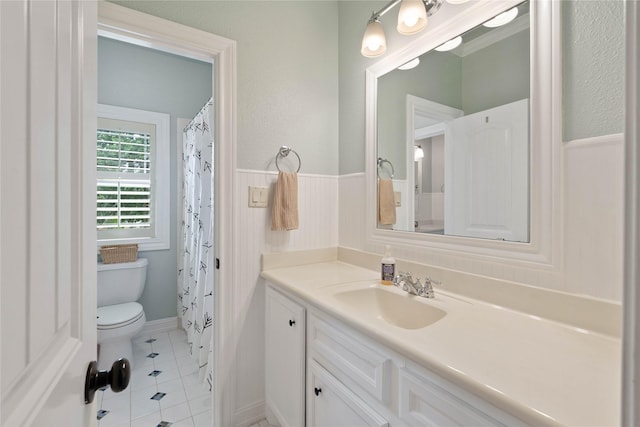 1858 Stoney Brook Ct, Conroe, TX 77304 - bathroom featuring vanity, toilet, tile patterned floors, and wainscoting