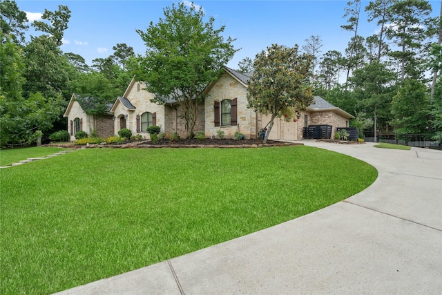 1858 Stoney Brook Ct, Conroe, TX 77304 - french country style house featuring concrete driveway and stone siding