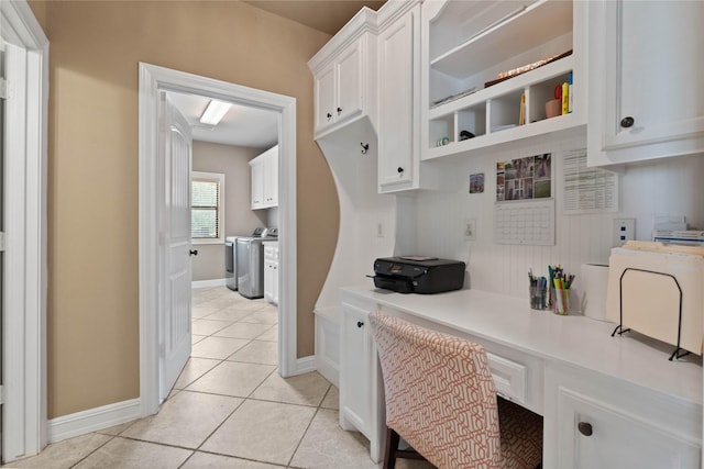 1858 Stoney Brook Ct, Conroe, TX 77304 - kitchen featuring independent washer and dryer, white cabinetry, light countertops, light tile patterned flooring, and baseboards