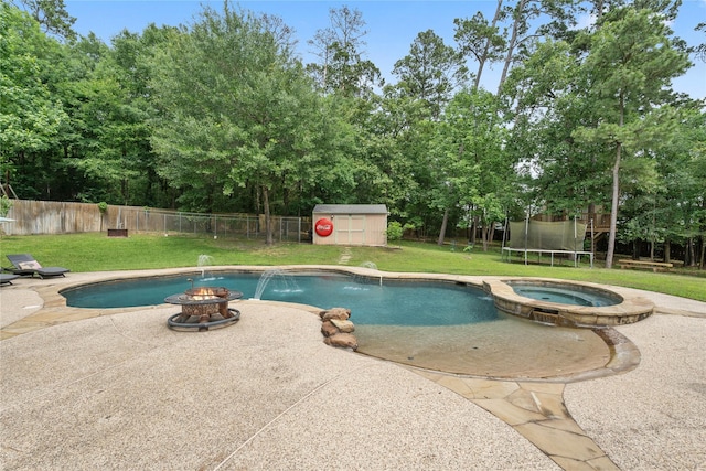 1858 Stoney Brook Ct, Conroe, TX 77304 - view of swimming pool featuring a fire pit, a patio area, a pool with connected hot tub, and view of scattered trees