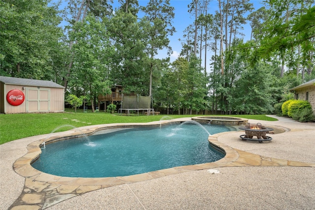 1858 Stoney Brook Ct, Conroe, TX 77304 - view of swimming pool with an outdoor fire pit, a yard, a trampoline, a patio area, and view of scattered trees